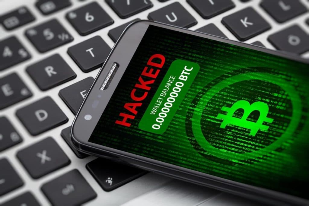 Someone committing one of the cryptocurrency crimes of hacking a smartphone for Bitcoins